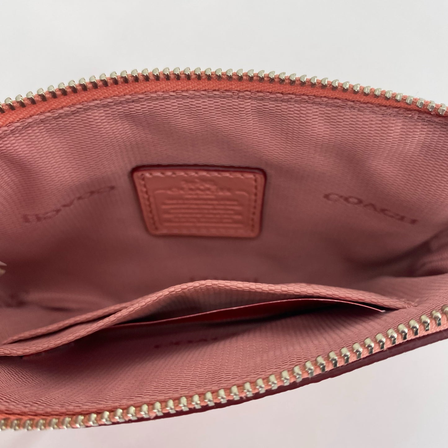 Peach COACH Leather Wristlet